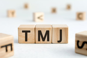 Blocks with letters spelling out “TMJ”